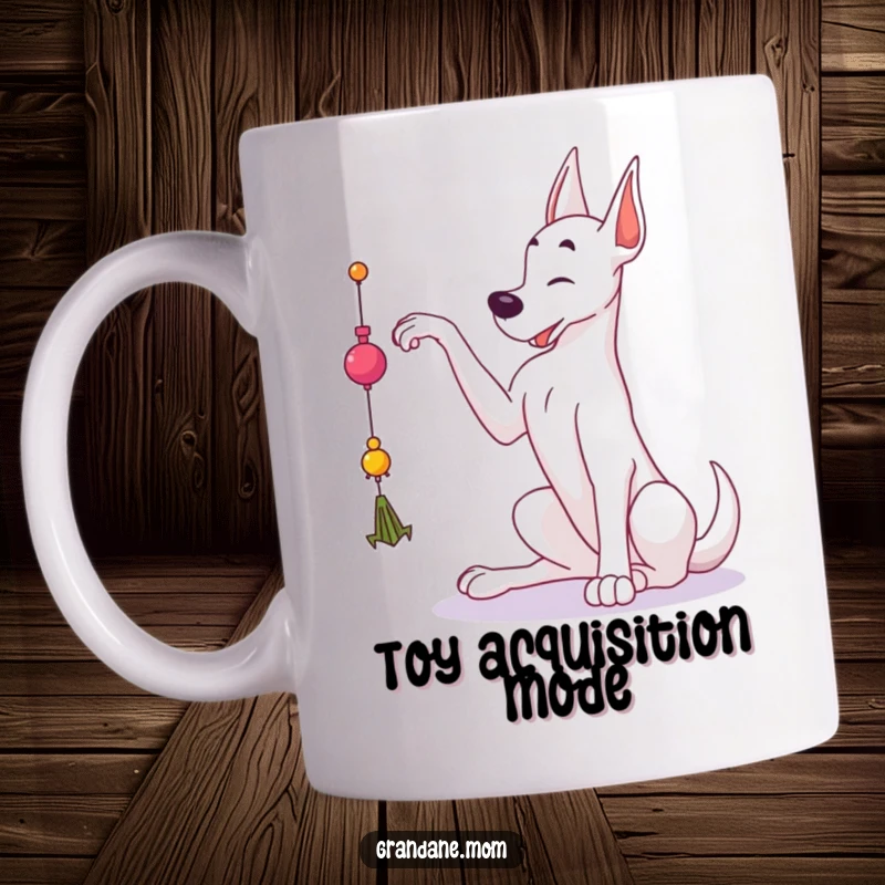 Funny Grand Dane mug showing a large dog gracefully reaching up with its paw towards a dangling toy, full of playful intent.