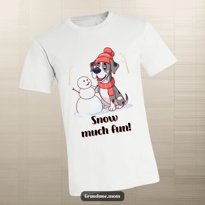 Funny Great Dane T-Shirt: A dog in a winter hat enthusiastically constructs a snowman, capturing playful winter energy.