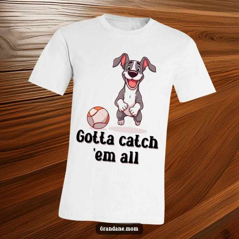 Funny T-Shirt depicts a happy Great Dane in mid-play, chasing a comically large ball during a game of fetch.